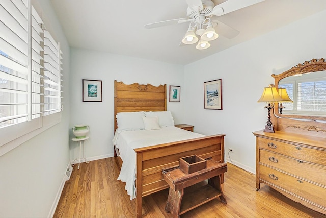 bedroom featuring baseboards, light wood-type flooring, and ceiling fan