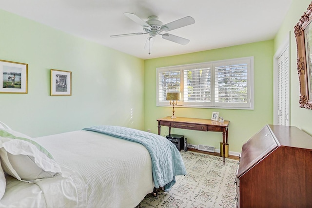 bedroom with visible vents, baseboards, and a ceiling fan