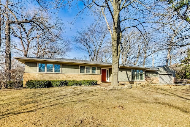 view of front of house with brick siding, driveway, and a garage