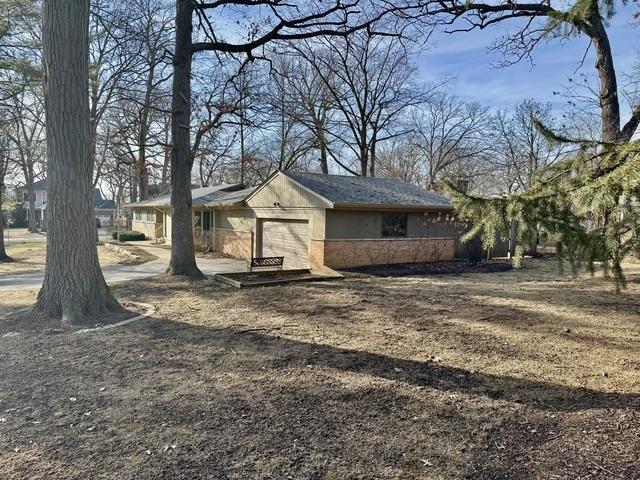 view of front of home with brick siding and an attached garage