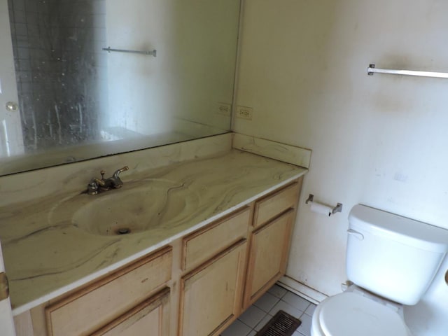 bathroom featuring tile patterned floors, toilet, and vanity