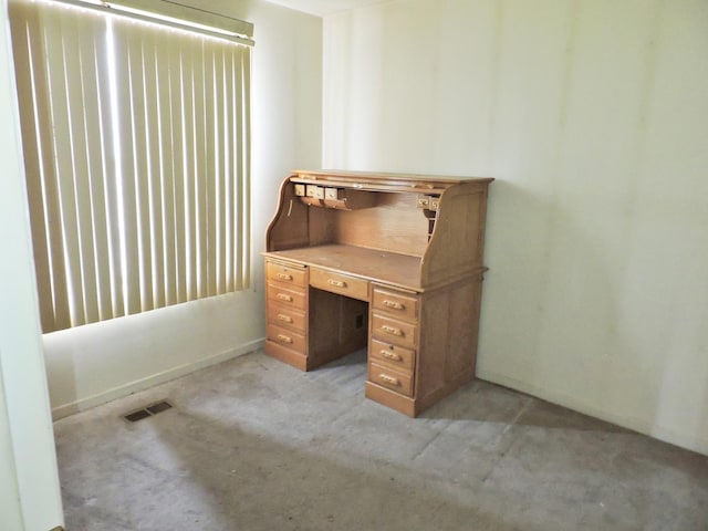 unfurnished office featuring visible vents and light colored carpet