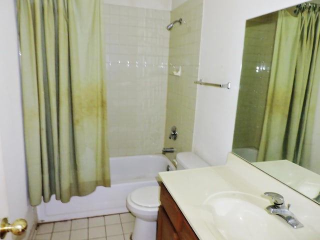 bathroom featuring vanity, tile patterned floors, toilet, and shower / bath combo with shower curtain