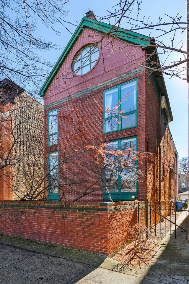 view of side of property featuring brick siding