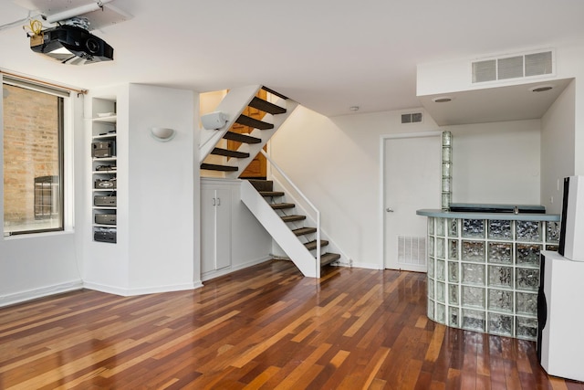 interior space featuring stairs, wood finished floors, and visible vents