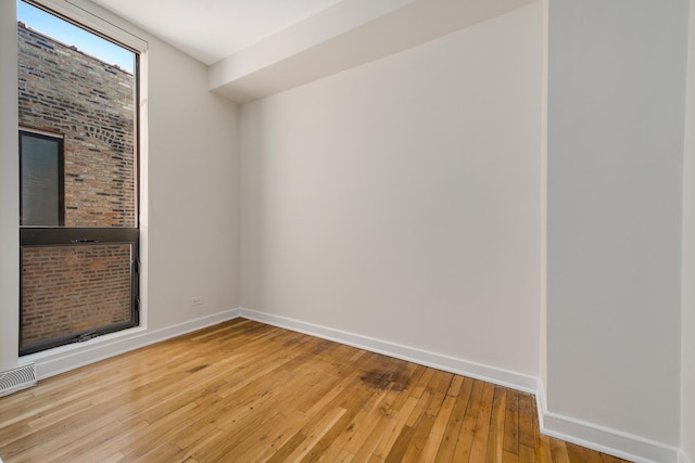 unfurnished room with visible vents, baseboards, and light wood finished floors