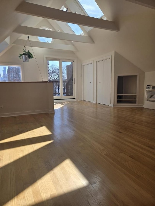 bonus room with baseboards, lofted ceiling with skylight, wood finished floors, and a wall mounted AC