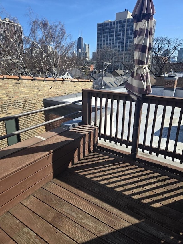 wooden deck with a city view