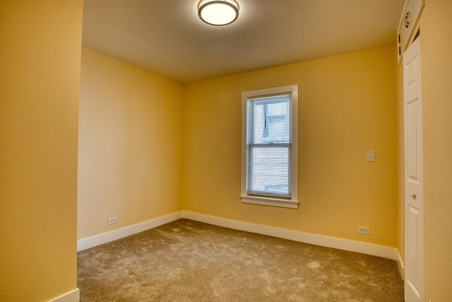 empty room with baseboards and carpet floors