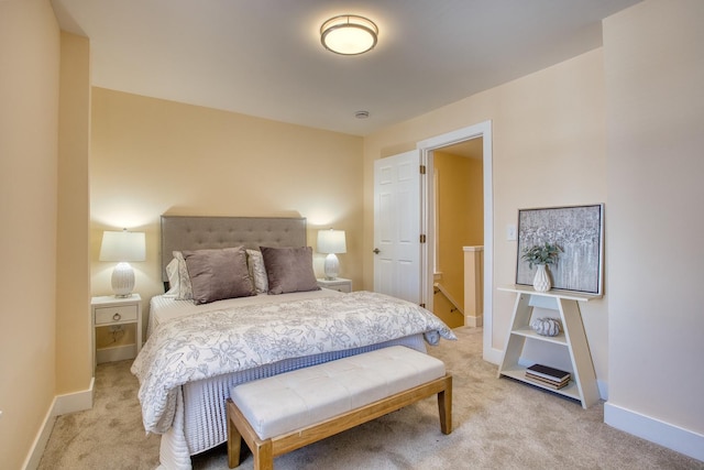 bedroom featuring baseboards and light carpet