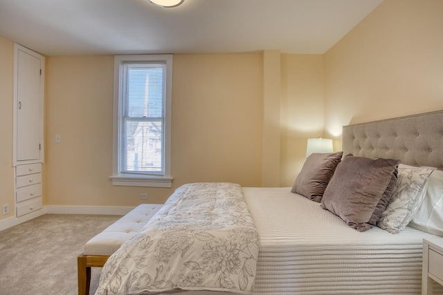 carpeted bedroom with baseboards