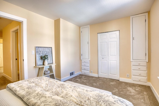 carpeted bedroom with baseboards, visible vents, and a closet