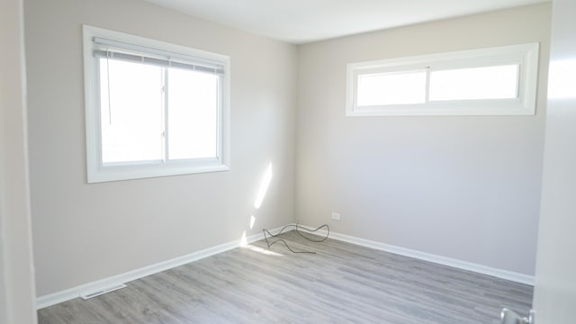 unfurnished room featuring baseboards and wood finished floors