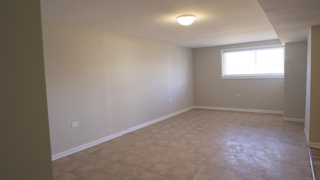 spare room with light floors and baseboards