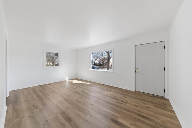 unfurnished room featuring wood finished floors and baseboards