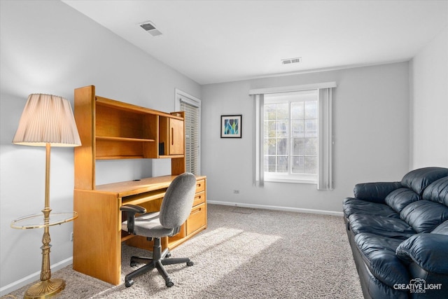 office space featuring visible vents, carpet flooring, and baseboards