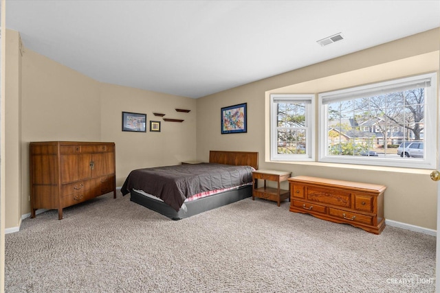 bedroom with baseboards, visible vents, and carpet floors