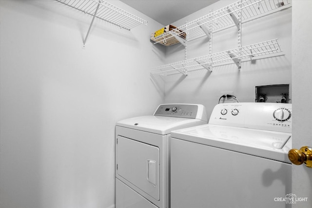 washroom featuring laundry area and washing machine and dryer