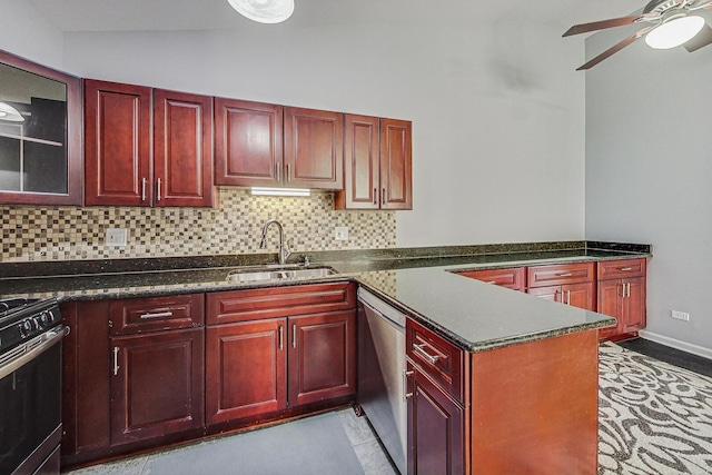 kitchen with a sink, stainless steel dishwasher, reddish brown cabinets, decorative backsplash, and gas range