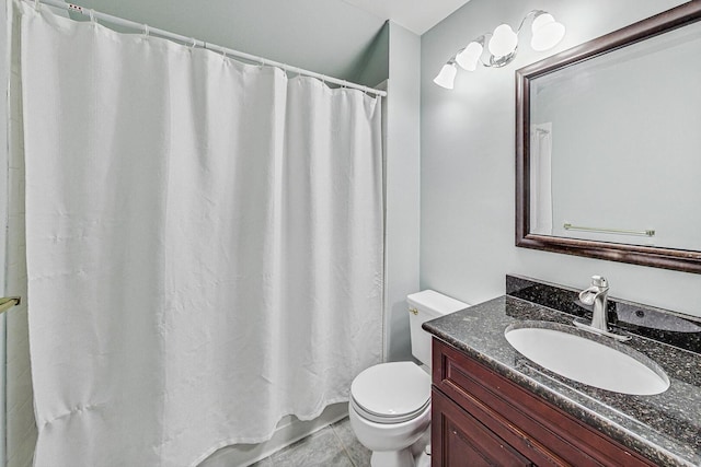 bathroom featuring toilet, vanity, and a shower with curtain