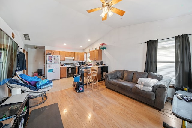 living room featuring visible vents, light wood-type flooring, lofted ceiling, recessed lighting, and a ceiling fan