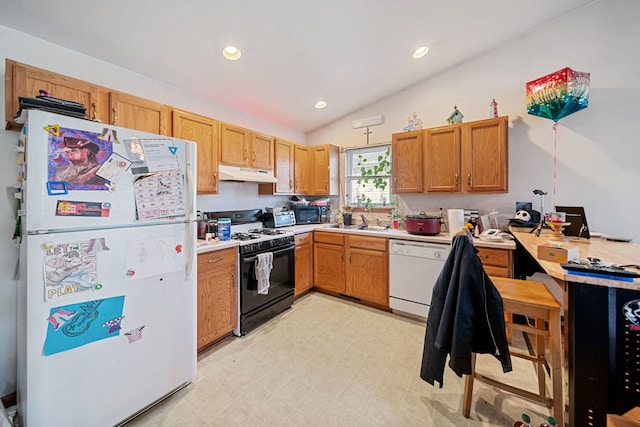 kitchen with white appliances, a sink, light countertops, vaulted ceiling, and under cabinet range hood