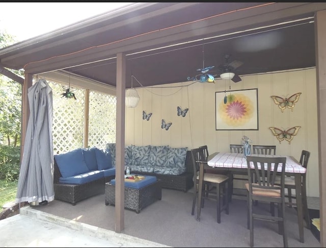 view of patio with outdoor dining area, an outdoor hangout area, and a ceiling fan