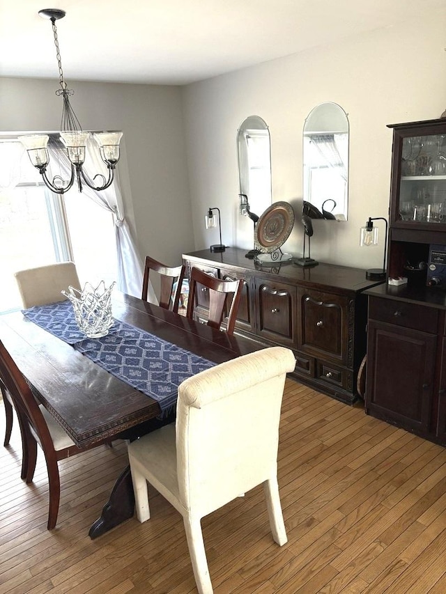 dining space with a chandelier and hardwood / wood-style flooring