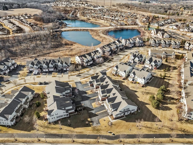 drone / aerial view with a residential view and a water view