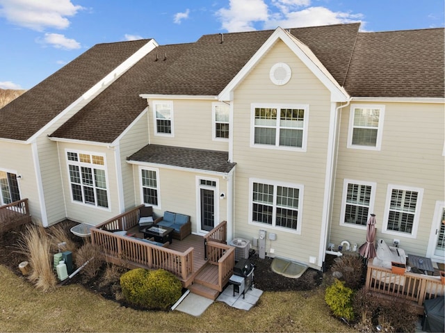 back of property featuring a wooden deck, an outdoor hangout area, roof with shingles, and central AC