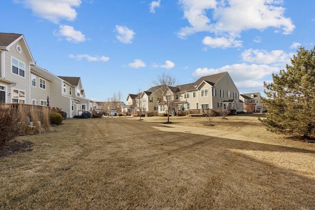 exterior space featuring a residential view and a yard