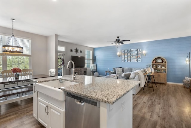 kitchen featuring stainless steel dishwasher, dark wood-type flooring, plenty of natural light, and a sink