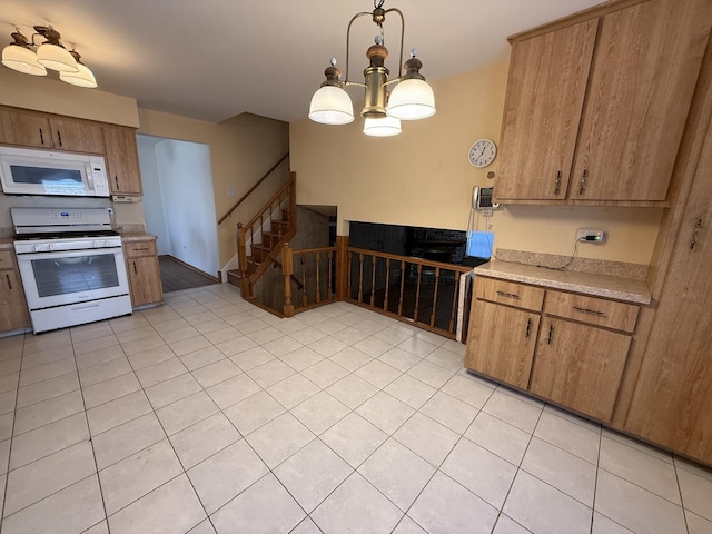 kitchen featuring white appliances, brown cabinetry, light countertops, light tile patterned floors, and hanging light fixtures