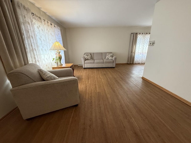 living room featuring baseboards and wood finished floors