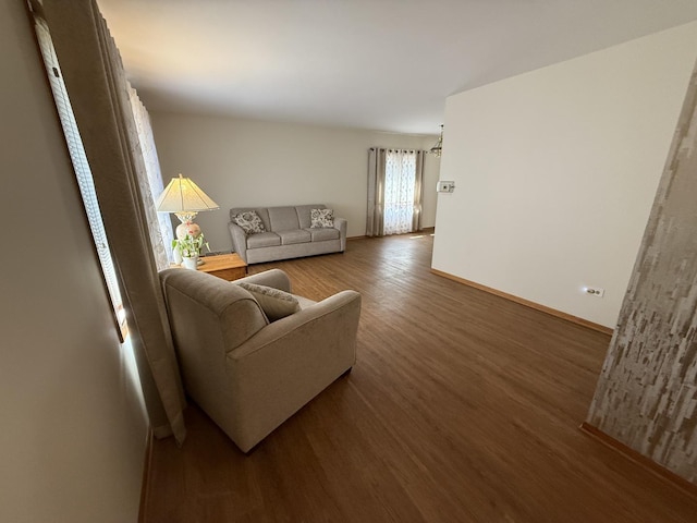 living area featuring baseboards and wood finished floors