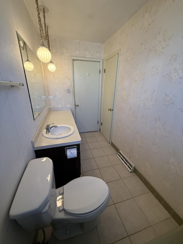 half bathroom with vanity, visible vents, wallpapered walls, tile patterned floors, and toilet