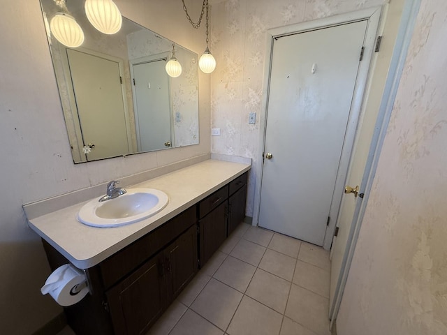 bathroom featuring tile patterned floors, vanity, and wallpapered walls