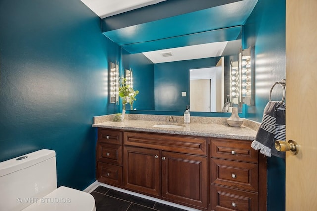 bathroom featuring tile patterned floors, toilet, and vanity