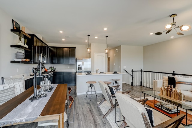 dining area with wood finished floors and recessed lighting