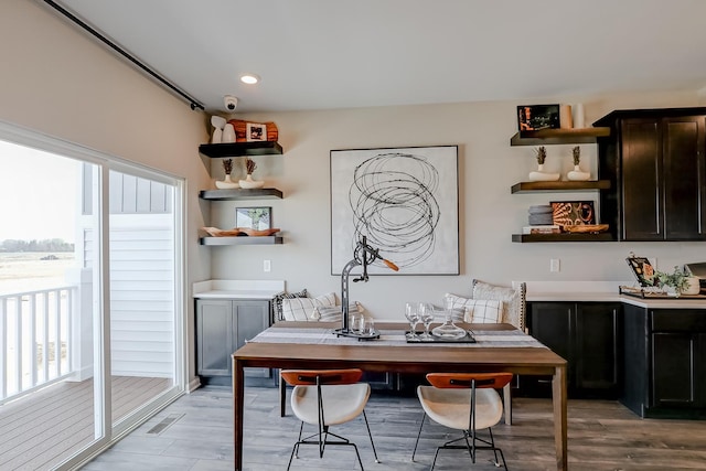 dining room featuring light wood finished floors, visible vents, and recessed lighting