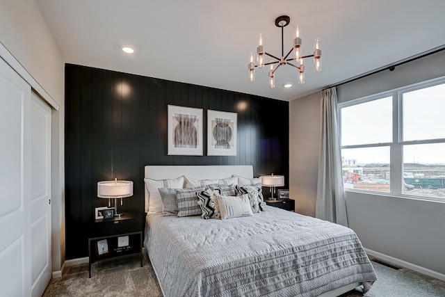 bedroom featuring a closet, visible vents, baseboards, and an inviting chandelier