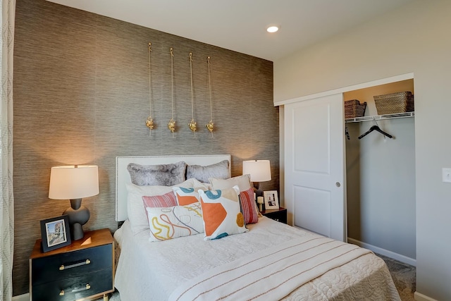 bedroom with a closet, recessed lighting, and baseboards