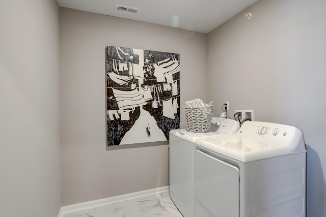 washroom with laundry area, visible vents, baseboards, marble finish floor, and independent washer and dryer