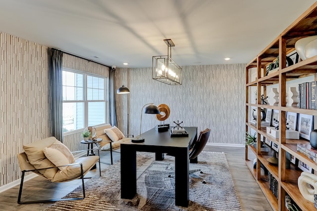 home office featuring a chandelier, baseboards, and wood finished floors