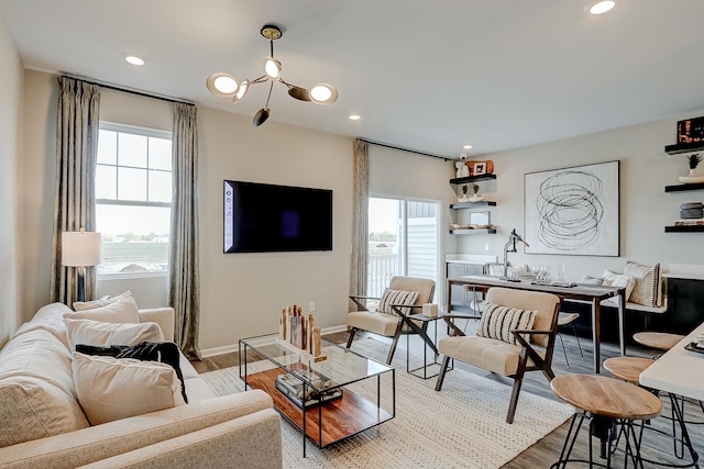 living room with baseboards, wood finished floors, and recessed lighting