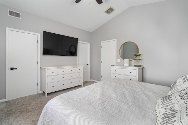 carpeted bedroom with vaulted ceiling, a ceiling fan, and visible vents