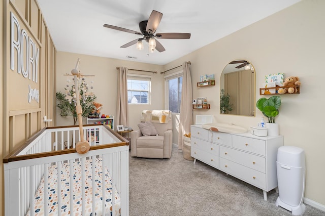 bedroom with carpet flooring, visible vents, baseboards, and ceiling fan