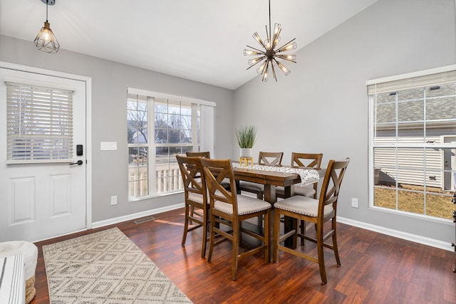 dining space with wood finished floors, baseboards, visible vents, an inviting chandelier, and lofted ceiling