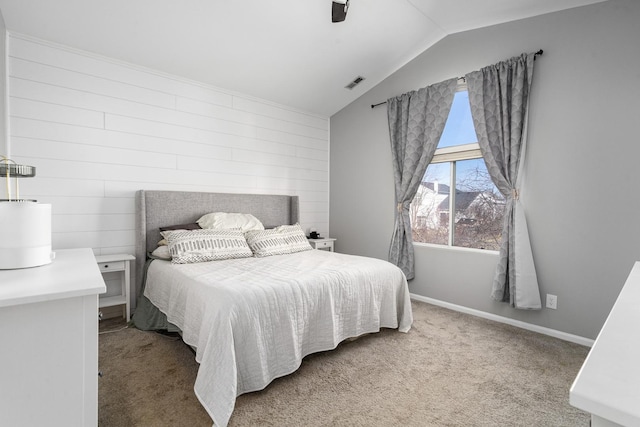 carpeted bedroom featuring visible vents, lofted ceiling, baseboards, and a ceiling fan