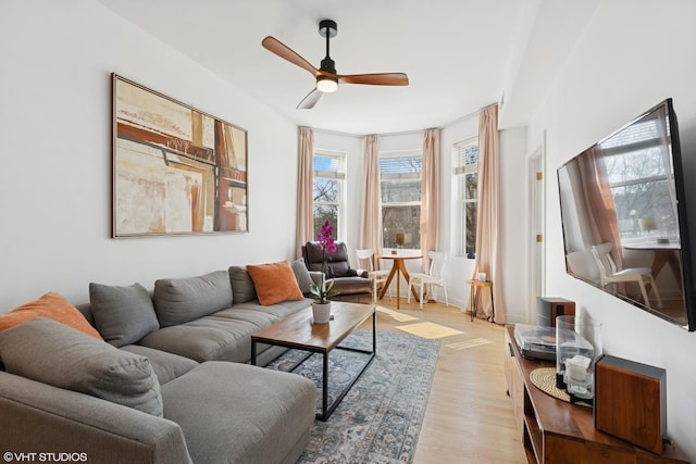 living room with light wood finished floors and ceiling fan